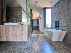 Modern primary bathroom with floating vanity and soaking tub